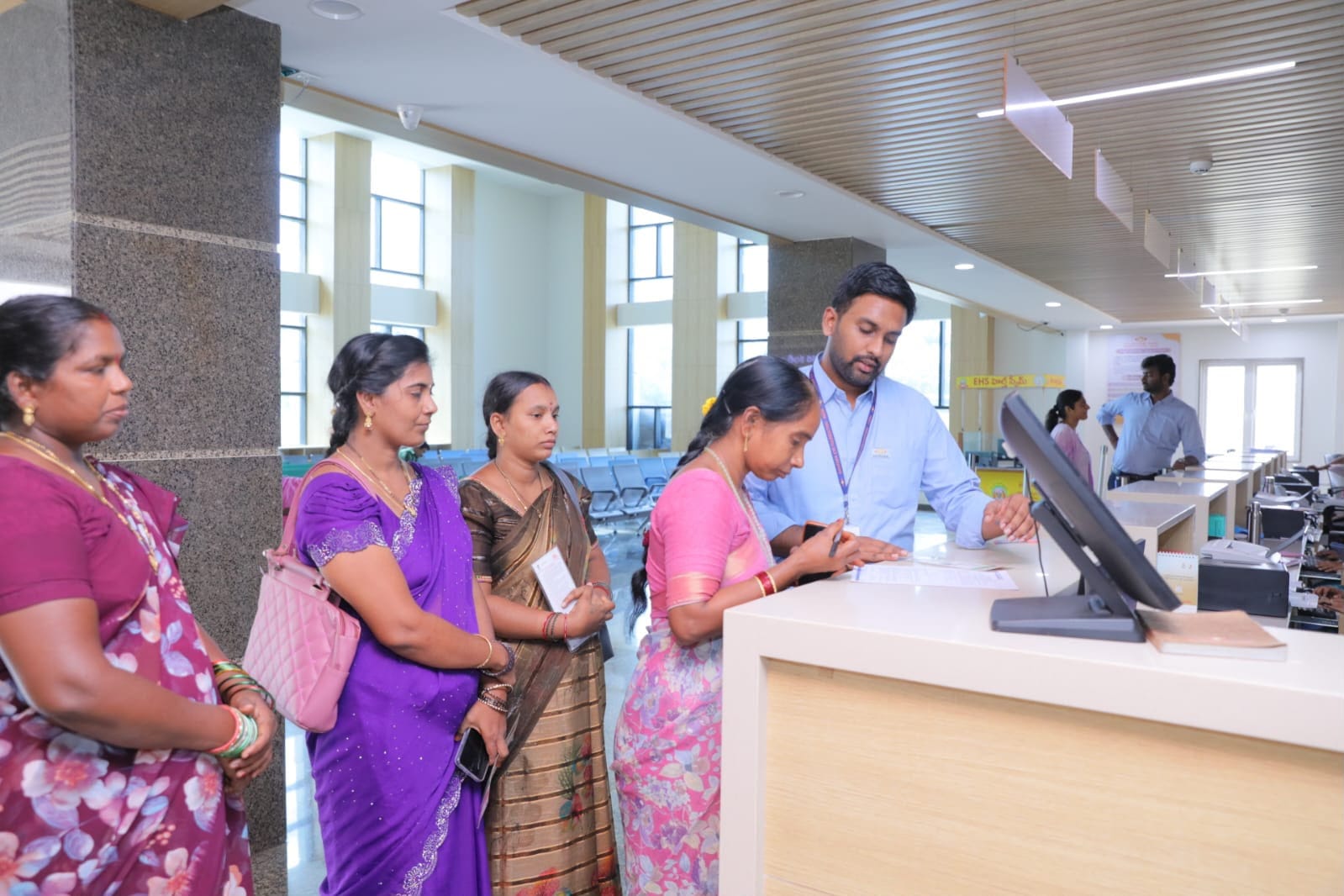 Student Anil Sai receiving a laptop at the Mangalagiri camp office