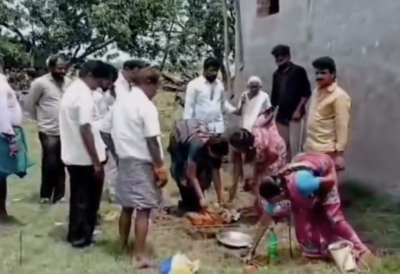 Student Anil Sai receiving a laptop at the Mangalagiri camp office