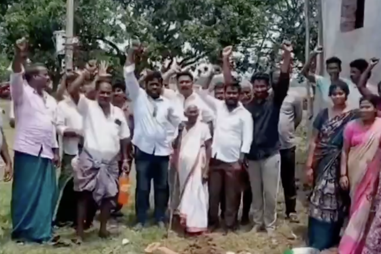 Student Anil Sai receiving a laptop at the Mangalagiri camp office