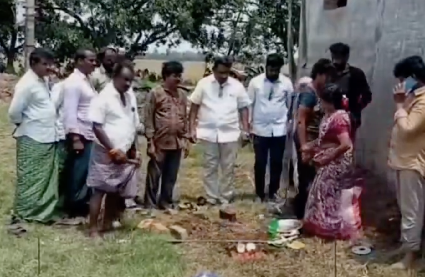 Student Anil Sai receiving a laptop at the Mangalagiri camp office