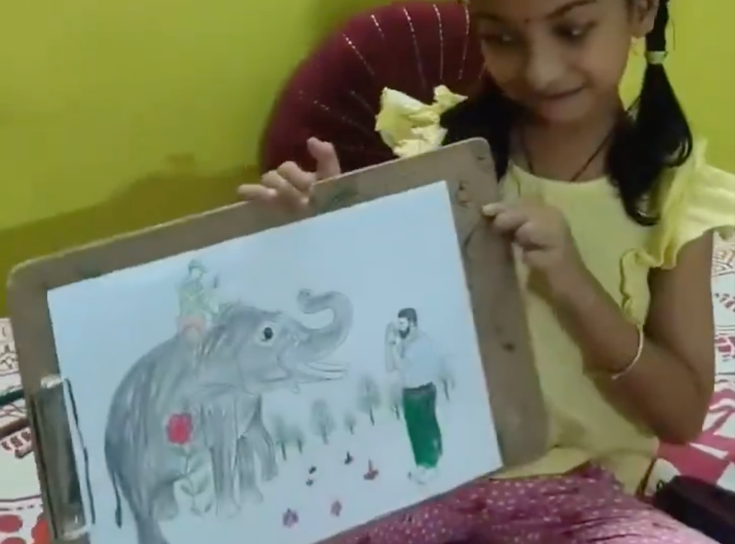 Little Hiramshi receiving a gift from Deputy CM Pawan Kalyan