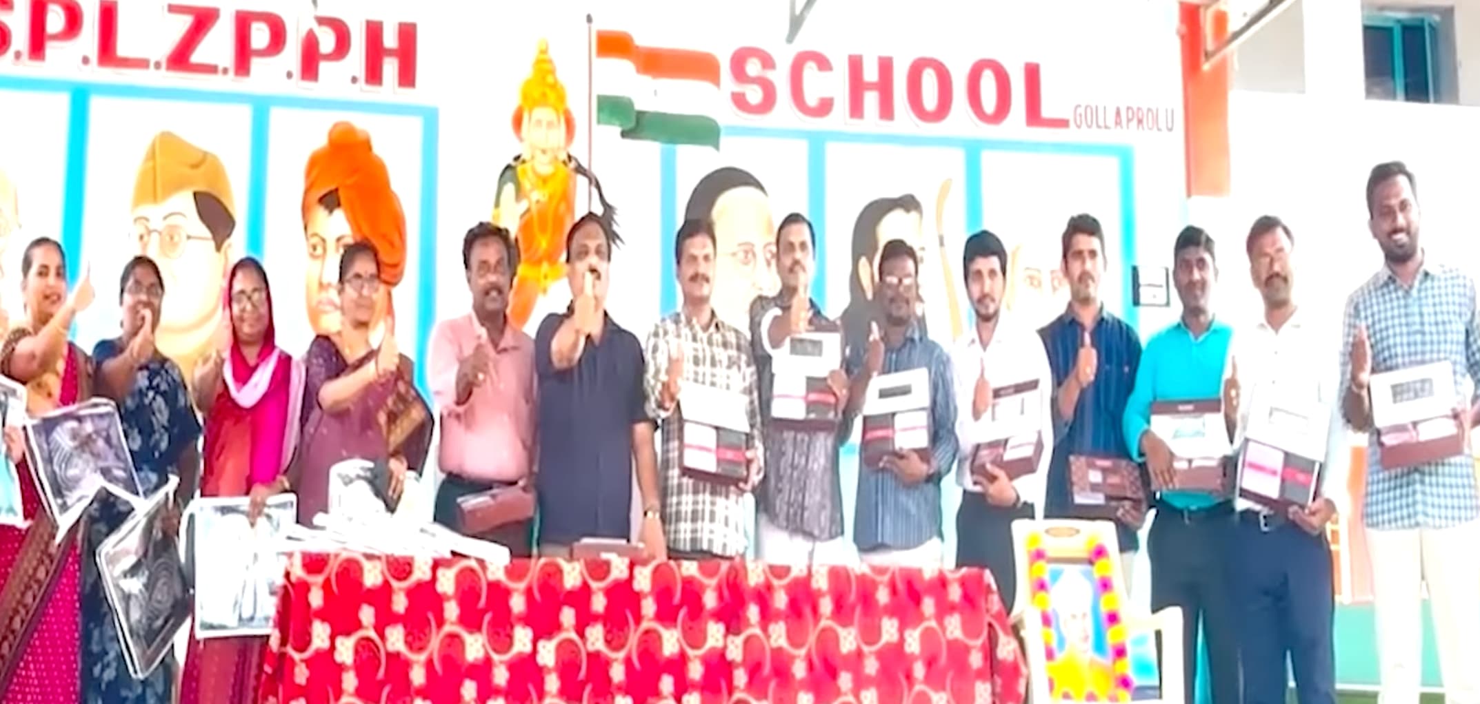 Students presenting clothes to teachers on behalf of Pawan Kalyan