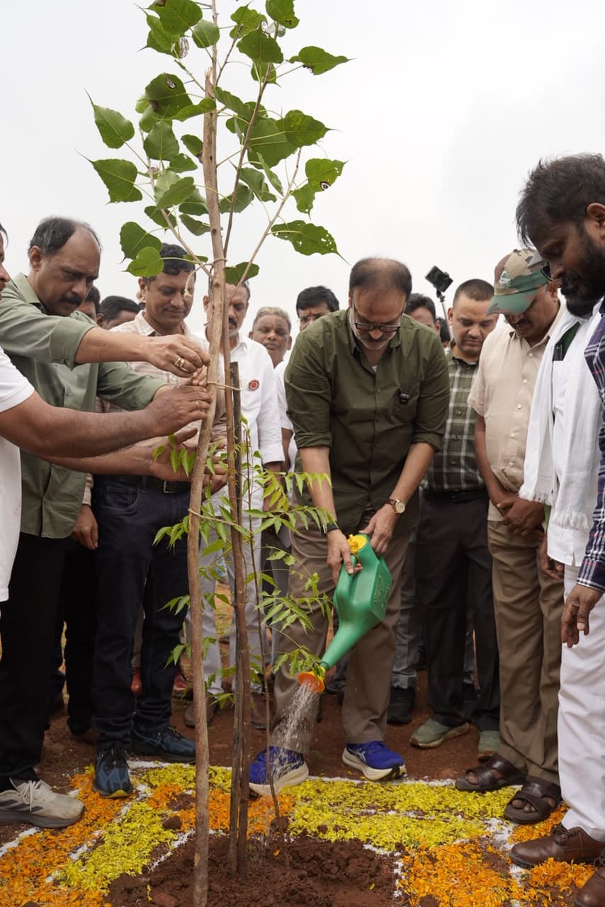 Naga Babu watering a newly planted ravi (peepal) sapling in the Gucchi Reserve Forest
