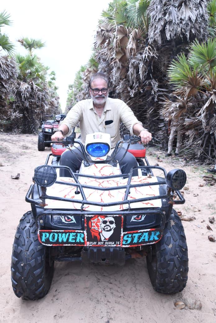 Naga Babu riding an all-terrain vehicle through the Great Green Wall palmyra plantation at Suryalanka