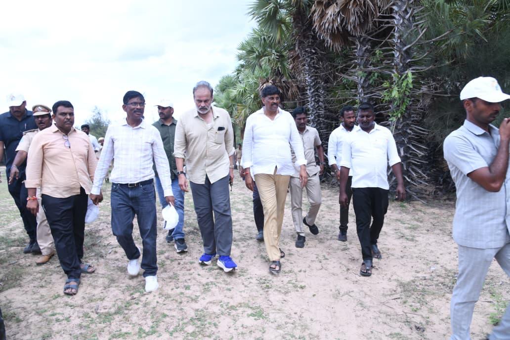 Naga Babu walking the Suryalanka coastal plantation site with forest officials and public representatives