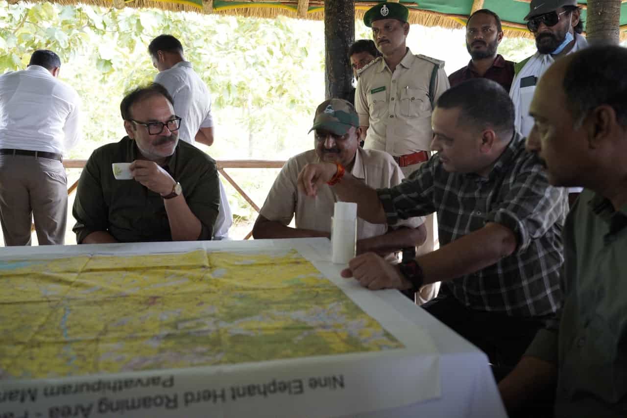 Naga Babu receiving a map briefing on elephant herd movement from Parvathipuram DFO S. Venkatesh