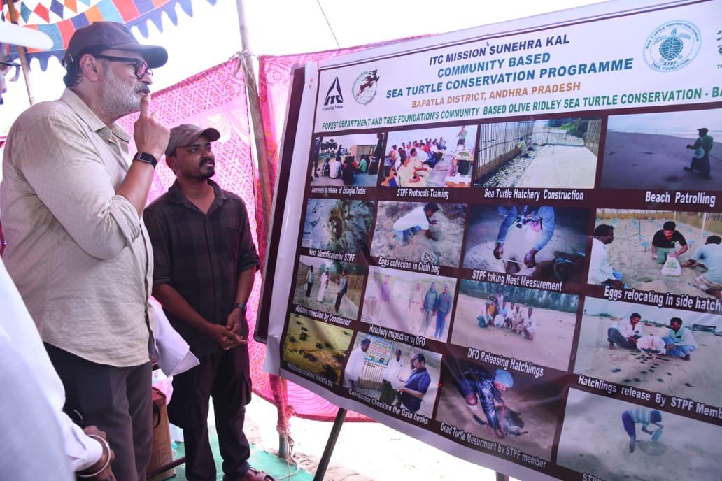 Naga Babu reviewing the Community Based Sea Turtle Conservation Programme display board in Bapatla district