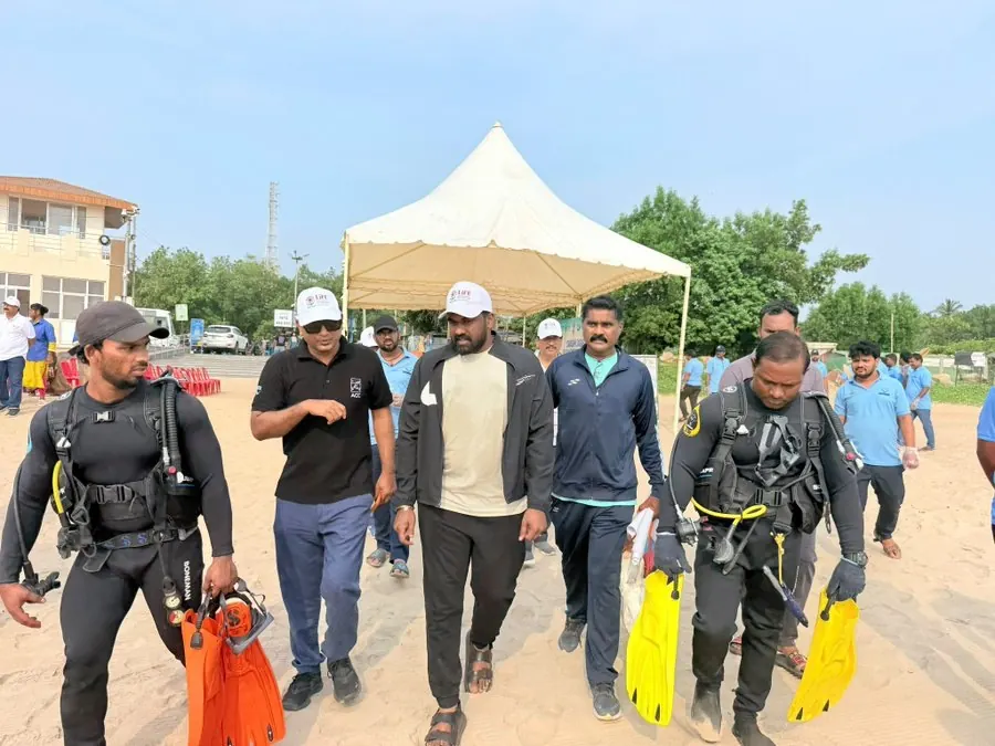 Walking with scuba divers on Rushikonda Beach during the Swachh Sagar Surakshit Sagar 5.0 programme