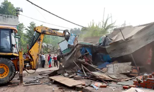 JCB machines demolishing house walls in Ippatam village during the Andhra Pradesh political controversy